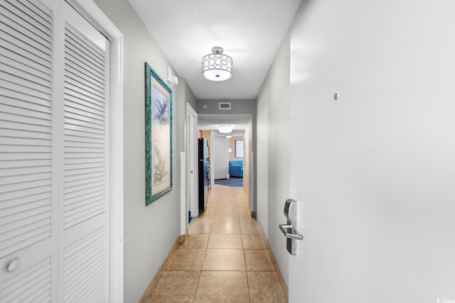 5200 N Ocean Blvd Unit 1231, Myrtle Beach, SC 29577 - hall featuring baseboards, light tile patterned flooring, and a textured ceiling