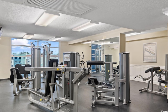 5200 N Ocean Blvd Unit 1231, Myrtle Beach, SC 29577 - exercise room featuring a textured ceiling and wainscoting