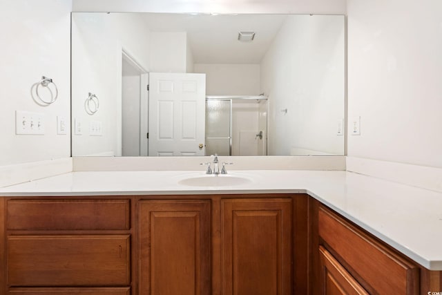 bathroom with vanity and an enclosed shower