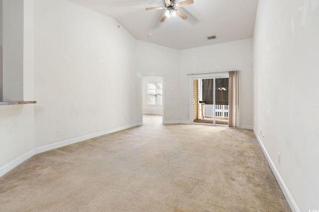 empty room with light colored carpet, ceiling fan, and lofted ceiling