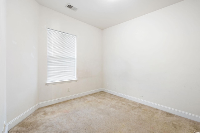 empty room featuring light carpet