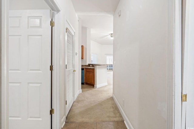 hallway with light colored carpet