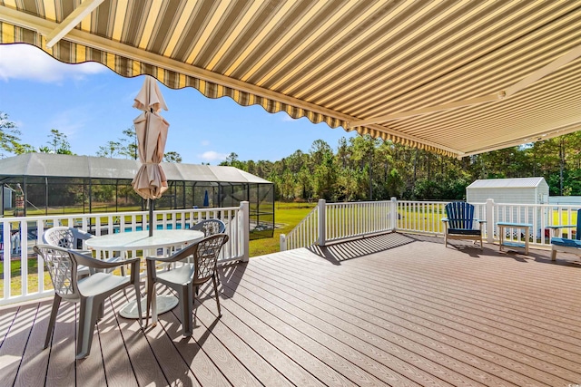 2580 Ash Little River Rd, Ash, NC 28420 - deck with outdoor dining area, a yard, and glass enclosure