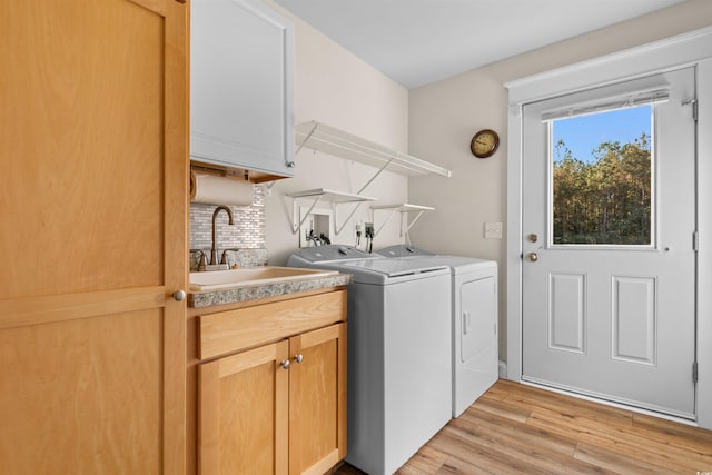 2580 Ash Little River Rd, Ash, NC 28420 - washroom featuring washer and dryer, cabinet space, and light wood-style floors