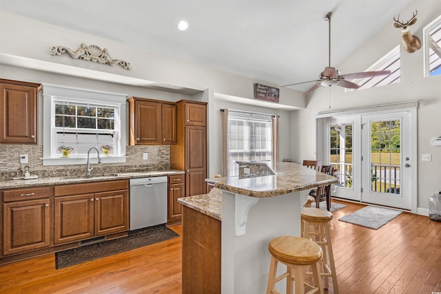 2580 Ash Little River Rd, Ash, NC 28420 - kitchen featuring dishwasher, a sink, a kitchen breakfast bar, and light wood-style floors