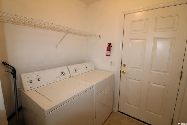 laundry room with washing machine and dryer and tile patterned floors