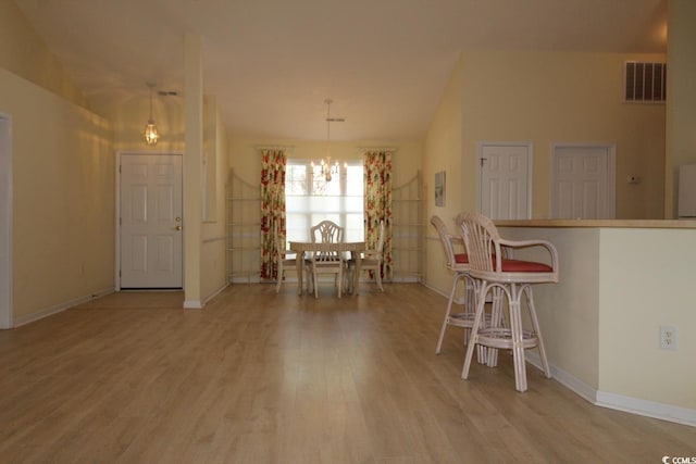 172 Collins Glen Dr, Murrells Inlet, SC 29576 - dining space with a chandelier, wood finished floors, and baseboards