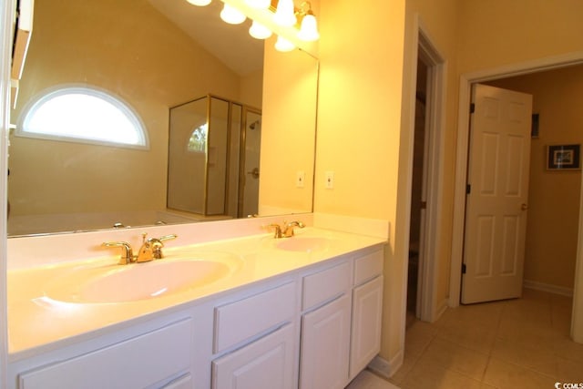 bathroom featuring tile patterned flooring, vanity, and a shower with shower door