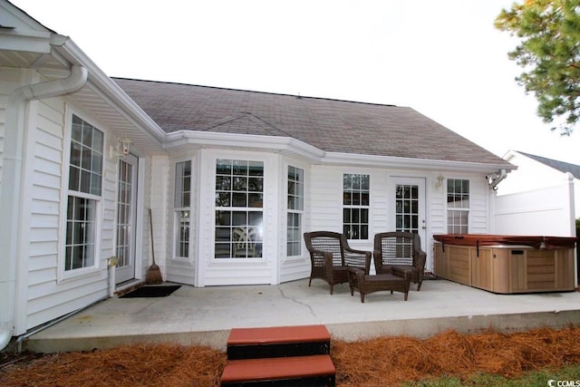 exterior space with a hot tub