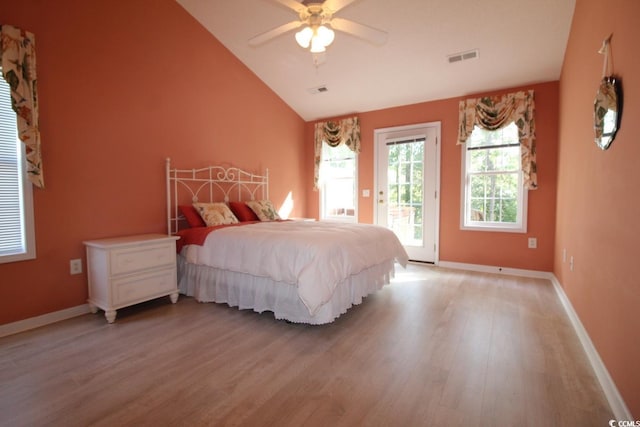 bedroom featuring ceiling fan, light hardwood / wood-style floors, access to outside, and vaulted ceiling