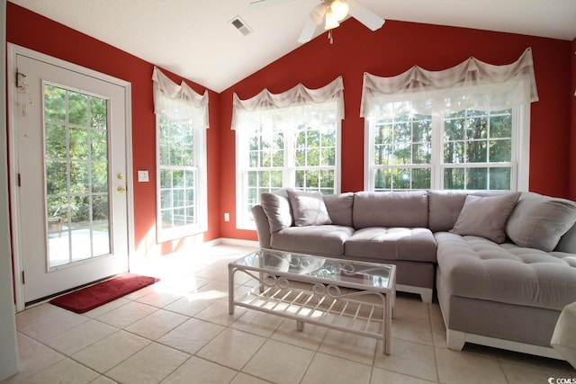 tiled living room with plenty of natural light, ceiling fan, and lofted ceiling