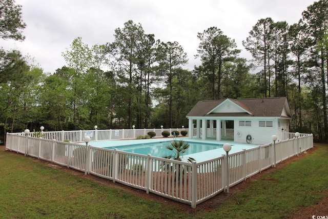 view of pool featuring a yard