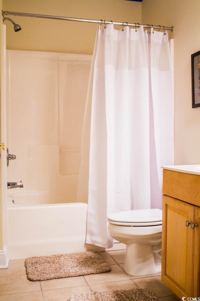 full bathroom featuring tile patterned floors, vanity, toilet, and shower / bath combo with shower curtain