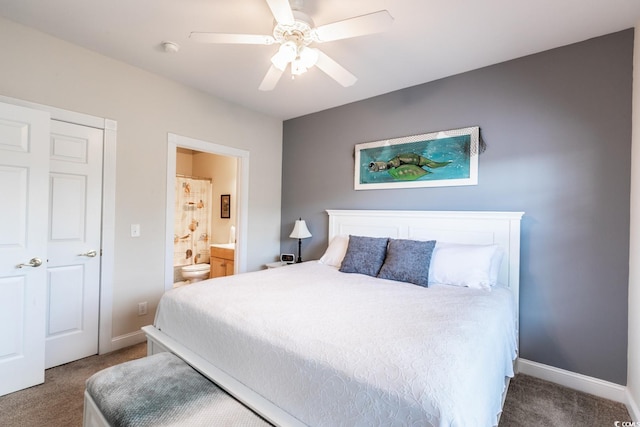 carpeted bedroom with ensuite bath and ceiling fan