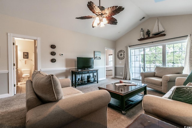 carpeted living room with ceiling fan and high vaulted ceiling