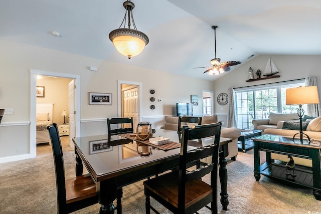 dining space featuring ceiling fan, carpet, and lofted ceiling