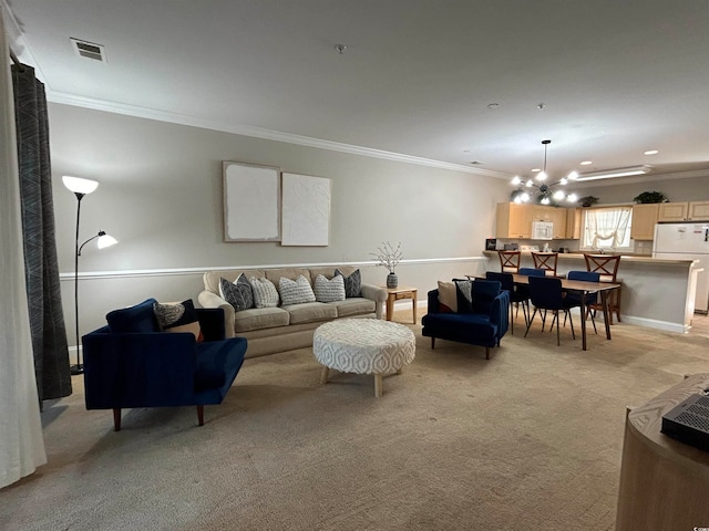 carpeted living room featuring a chandelier and ornamental molding