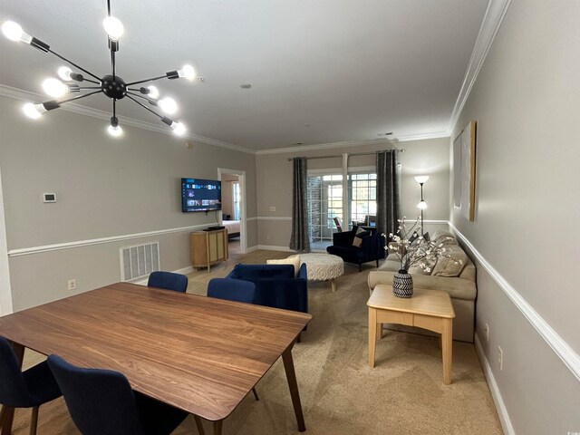 carpeted dining space with crown molding and an inviting chandelier