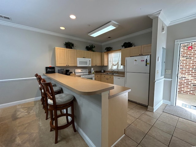 kitchen with kitchen peninsula, a kitchen breakfast bar, ornamental molding, white appliances, and sink