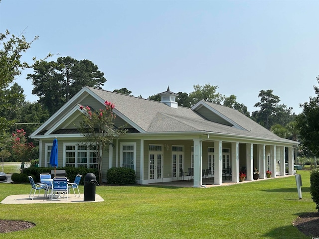 back of property featuring a patio area, a yard, and french doors