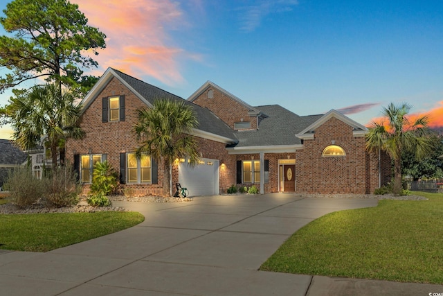 view of front of home featuring a yard and a garage