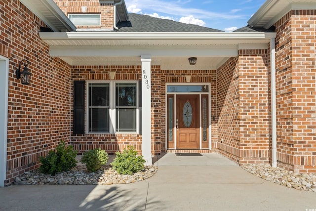 view of exterior entry featuring covered porch