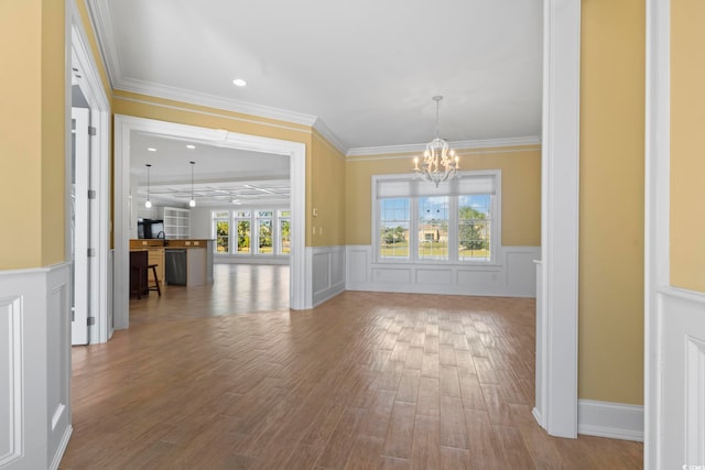 interior space featuring an inviting chandelier, hardwood / wood-style flooring, and ornamental molding