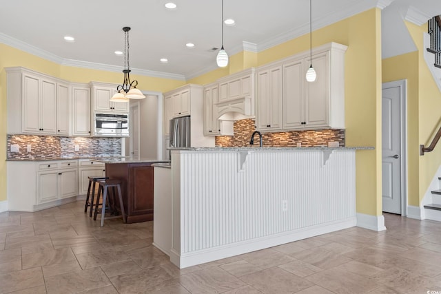 kitchen featuring pendant lighting, a breakfast bar area, stainless steel fridge, light stone counters, and kitchen peninsula