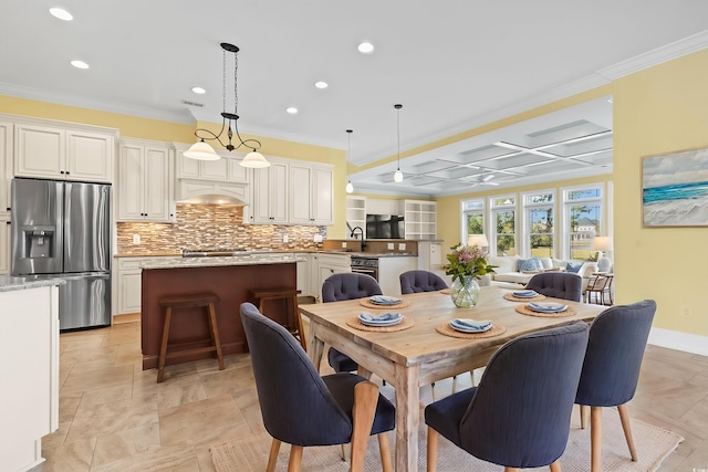 dining room featuring sink and ornamental molding