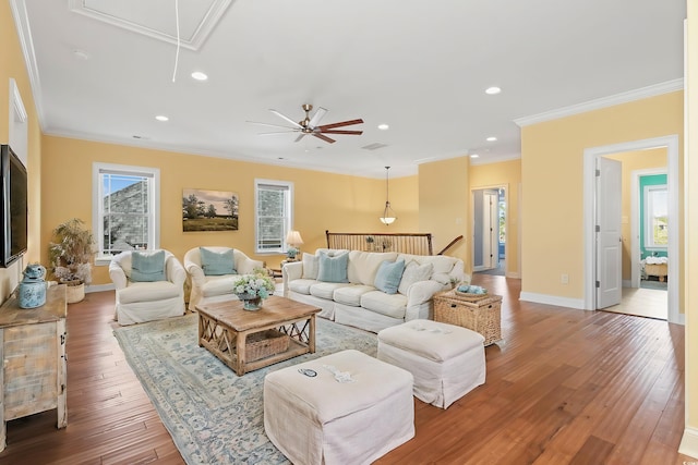 living room with hardwood / wood-style flooring and crown molding