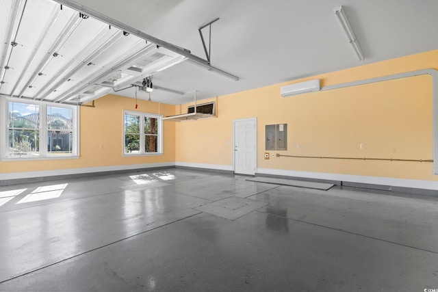 garage with a garage door opener, electric panel, and a wall mounted AC