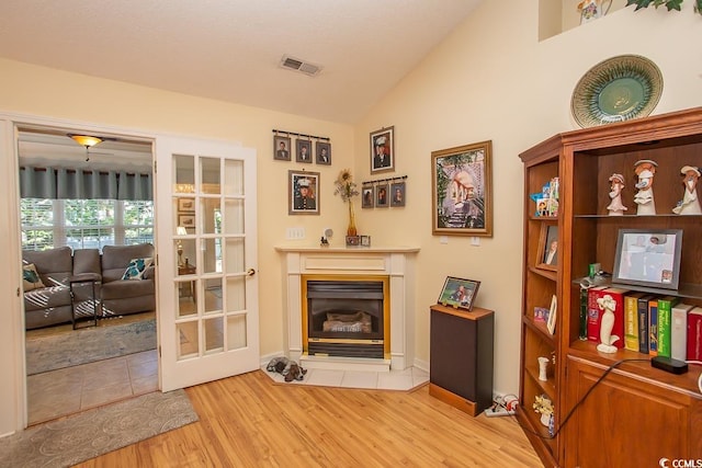 living area with light hardwood / wood-style flooring and vaulted ceiling