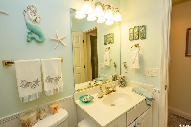 bathroom featuring vanity and toilet