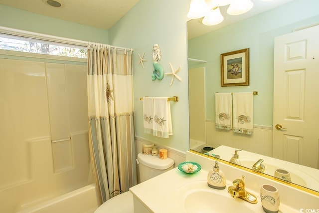 full bathroom featuring vanity, shower / bath combination with curtain, and toilet