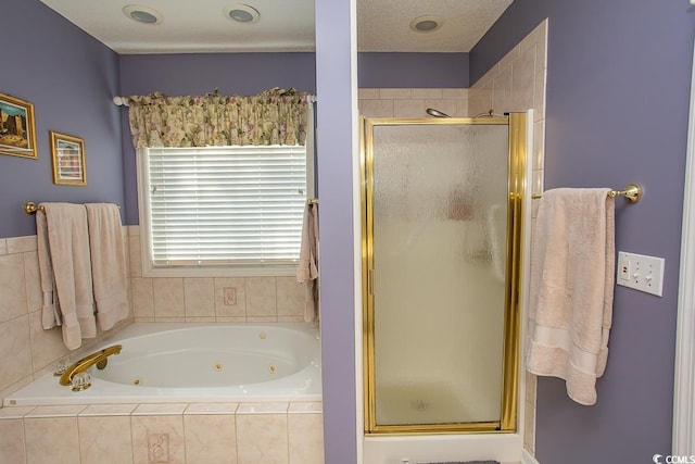 bathroom featuring independent shower and bath and a textured ceiling