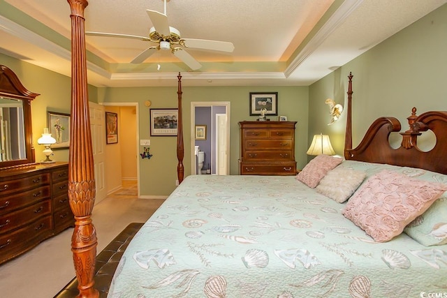 bedroom with carpet flooring, ceiling fan, and a tray ceiling