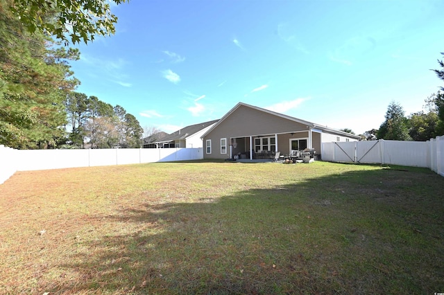 back of house with a yard