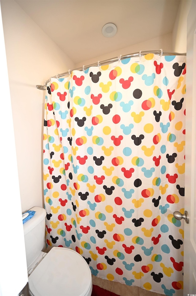 bathroom with toilet and curtained shower