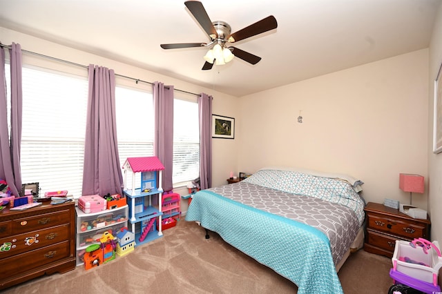 bedroom featuring light colored carpet and ceiling fan