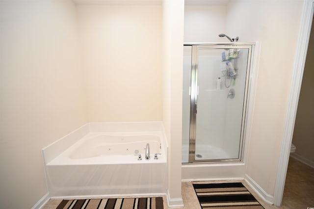 bathroom with shower with separate bathtub, tile patterned floors, and toilet