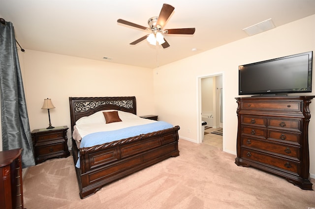 carpeted bedroom with ceiling fan and connected bathroom