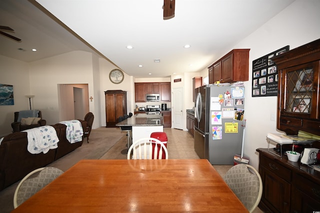 dining room with light colored carpet and ceiling fan