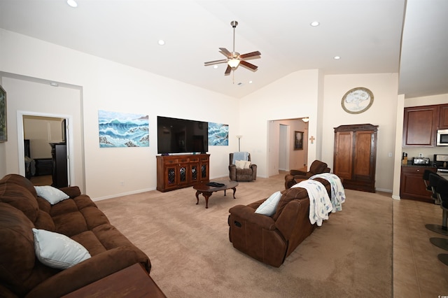 living room with ceiling fan, vaulted ceiling, and light carpet