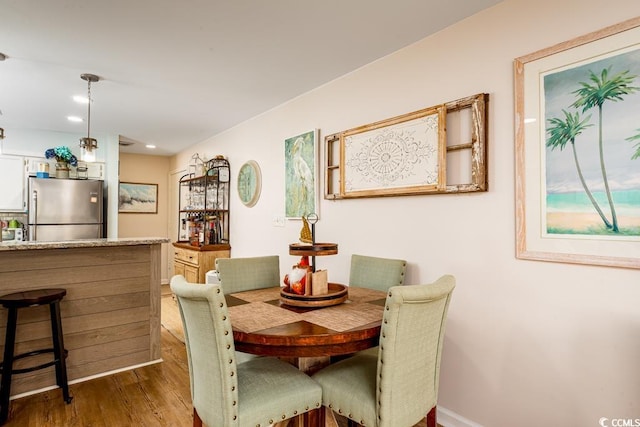 dining area with dark hardwood / wood-style flooring