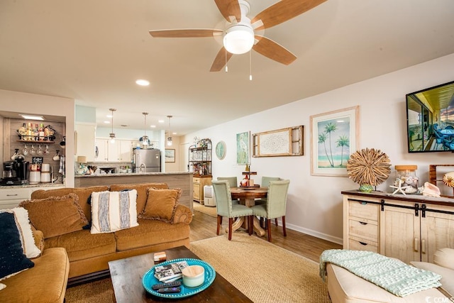 living room featuring wood-type flooring and ceiling fan