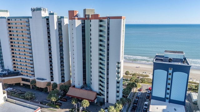 view of property featuring a water view and a beach view