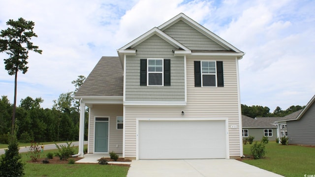 view of front of property with a front lawn and a garage