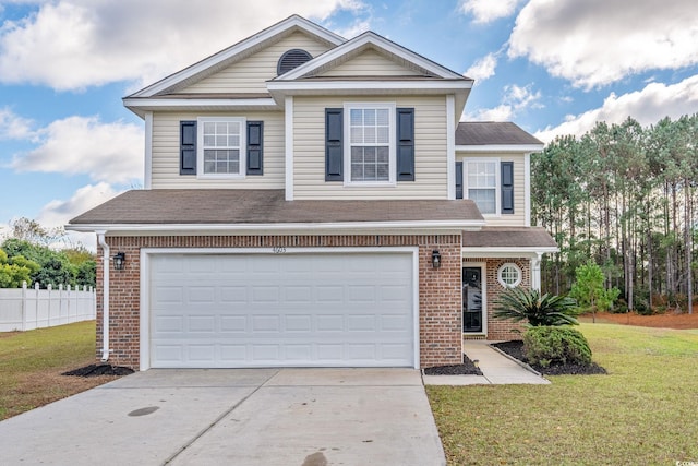 view of property featuring a front yard and a garage