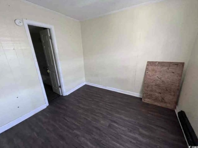 empty room featuring dark hardwood / wood-style flooring