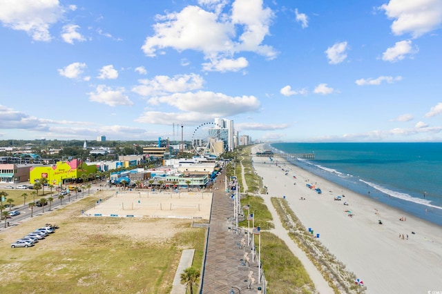 birds eye view of property featuring a water view and a beach view